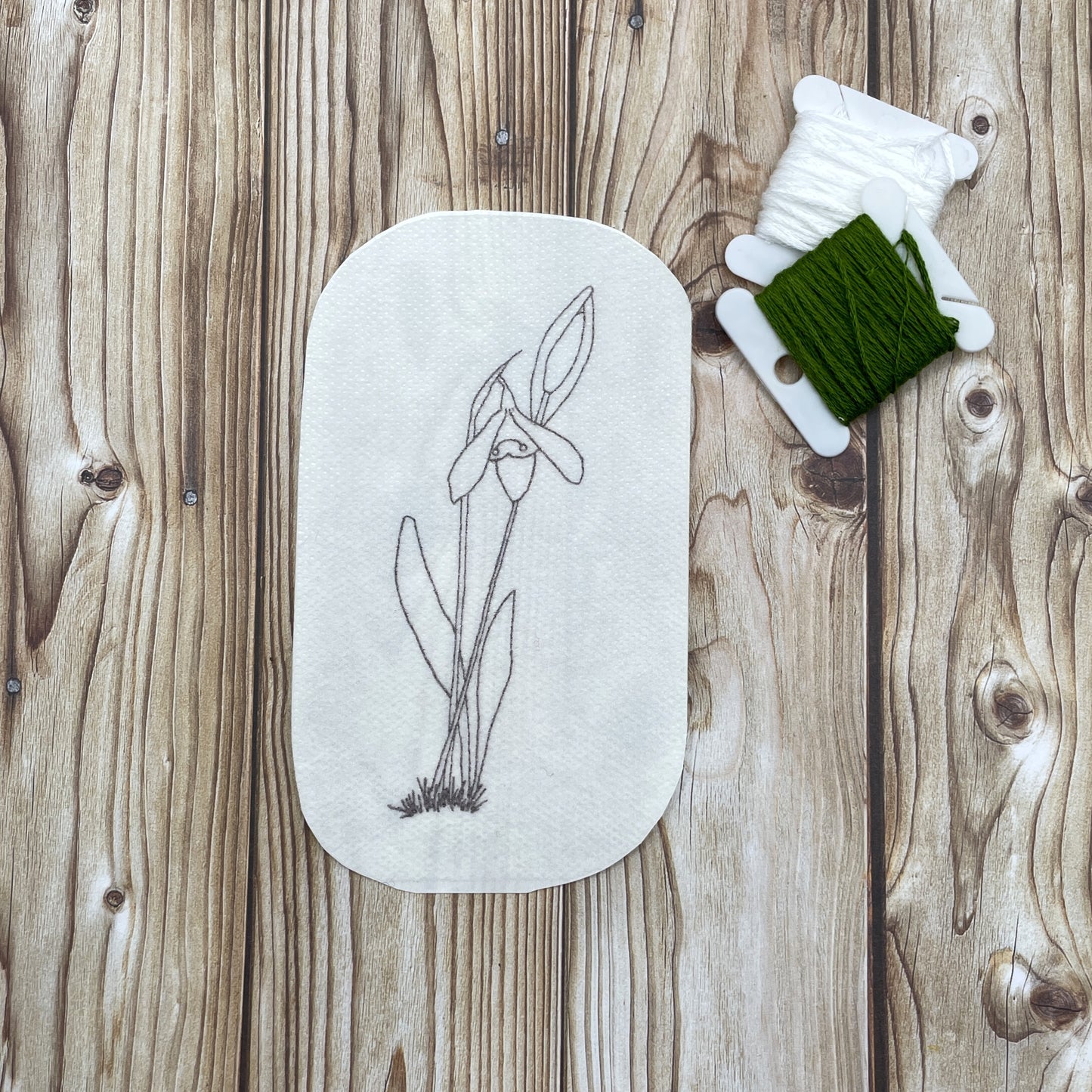 Embroidery sticker design - a small cluster of snowdrops, one in flower and one in bud.