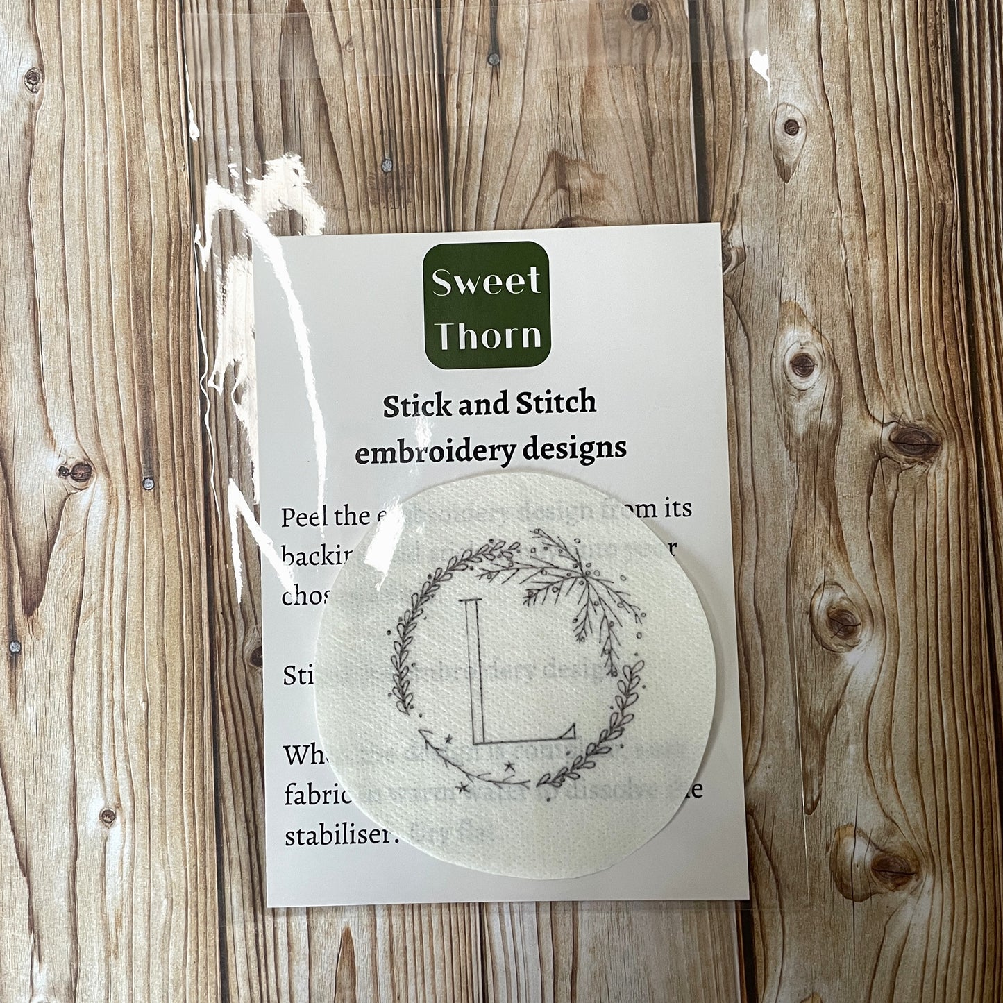 Embroidery sticker in cellophane bag with instructions.