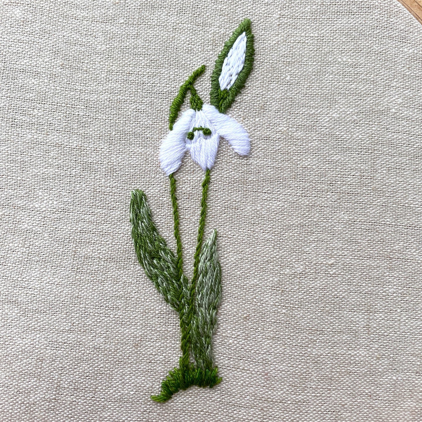 Embroidered snowdrop cluster.