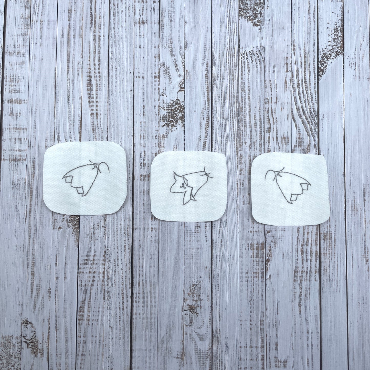 Three small harebell flower head embroidery stickers.