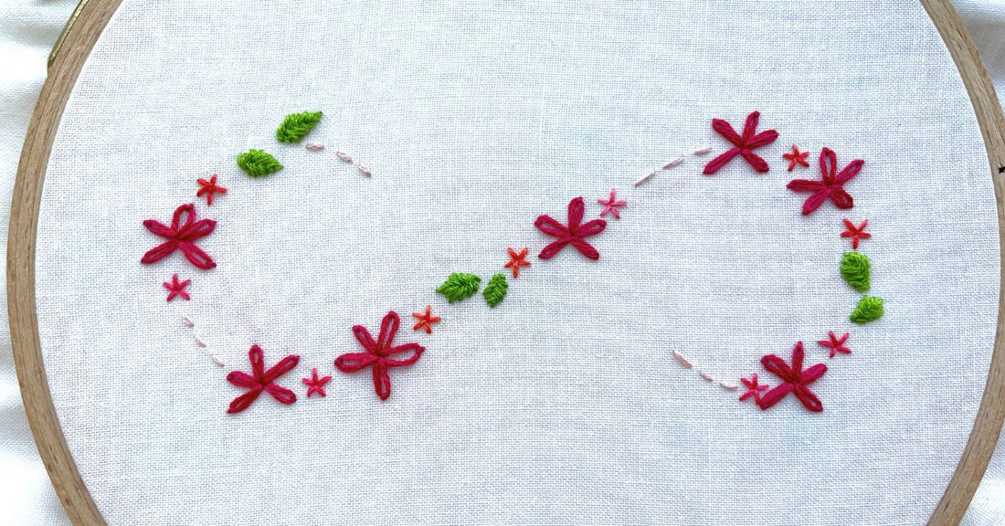 Floral S swirl design made of simple embroidered flowers and leaves.