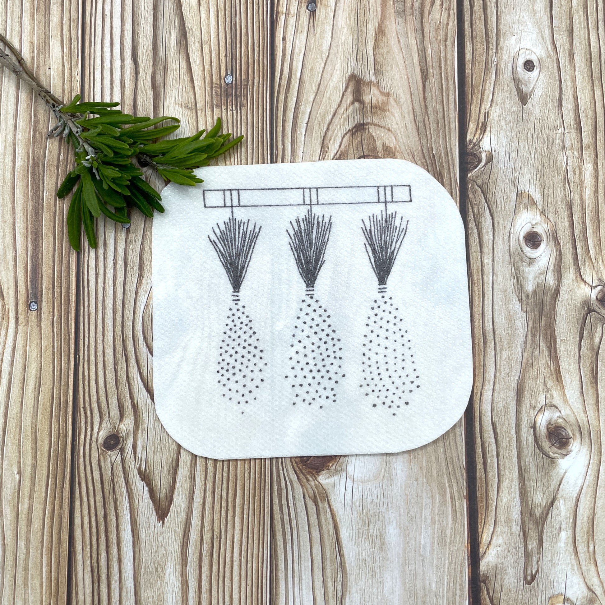 Embroidery sticker showing three bunches of lavender hung up to dry.