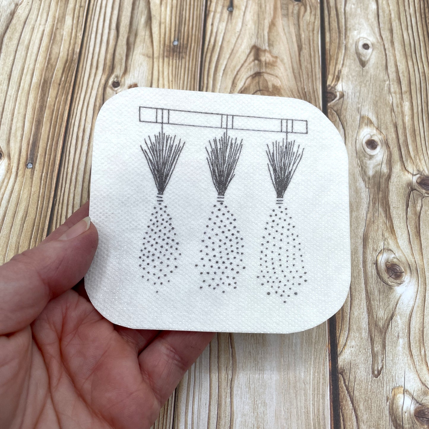 Lavender embroidery sticker held in a hand.