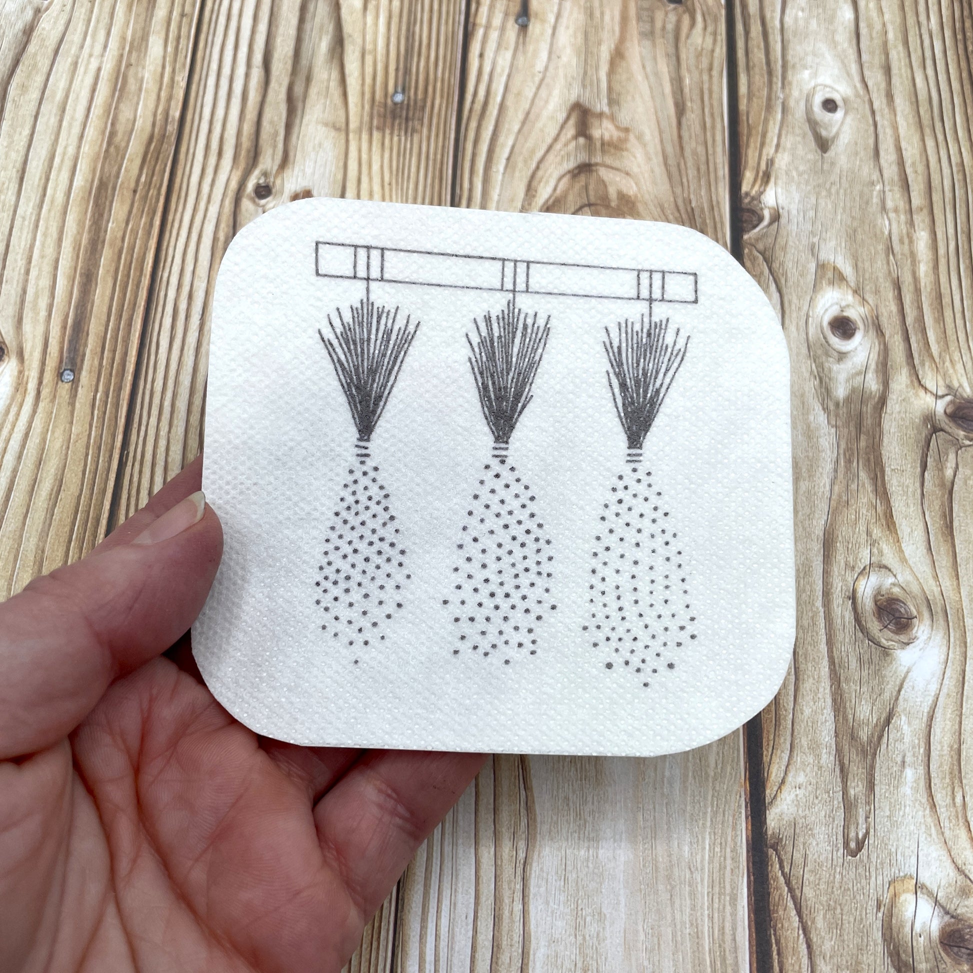 Lavender embroidery sticker held in a hand.